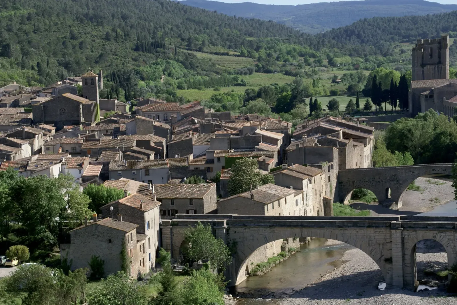 Lagrasse village aerial view over the river Orbieu, Aude