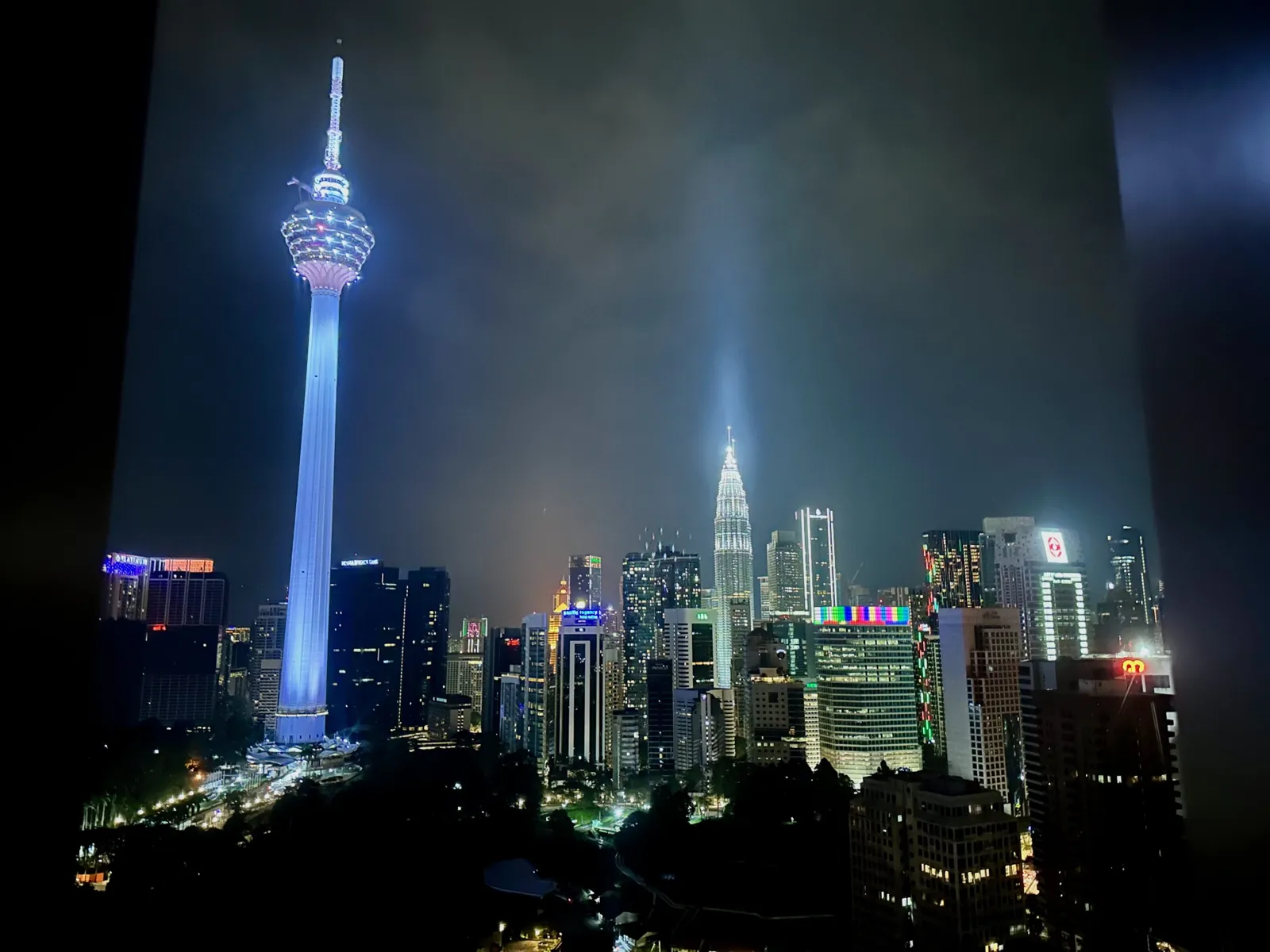 Kuala Lumpur skyline at night — Petronas Twin Towers illuminated above the city