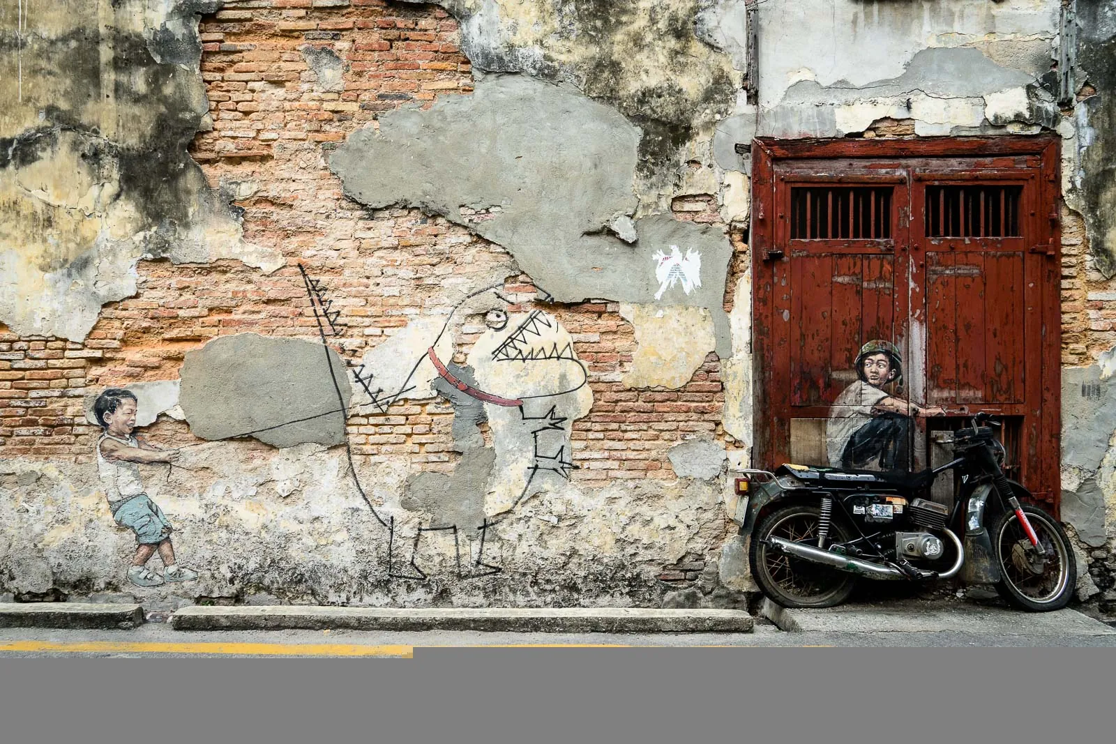 Ernest Zacharevic street-art mural on a George Town shophouse wall