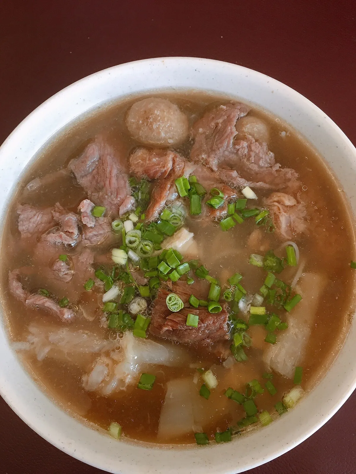 Ngiu chap — mixed beef-noodle soup with tripe and meatballs