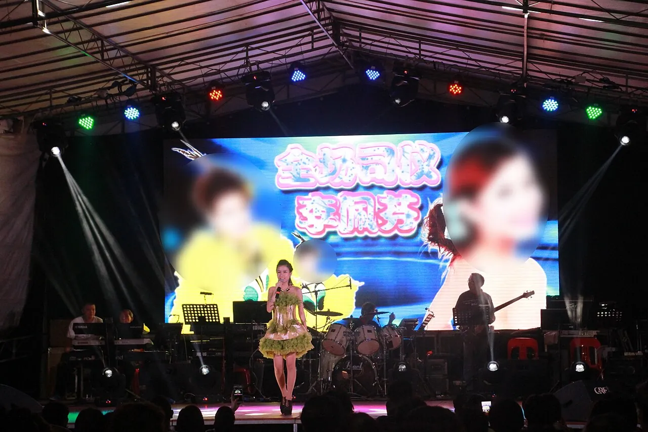 Getai performer on a neon stage, Singapore