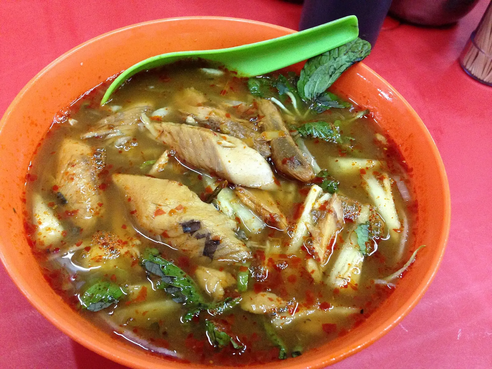 A bowl of Penang assam laksa with pineapple, mint and chilli