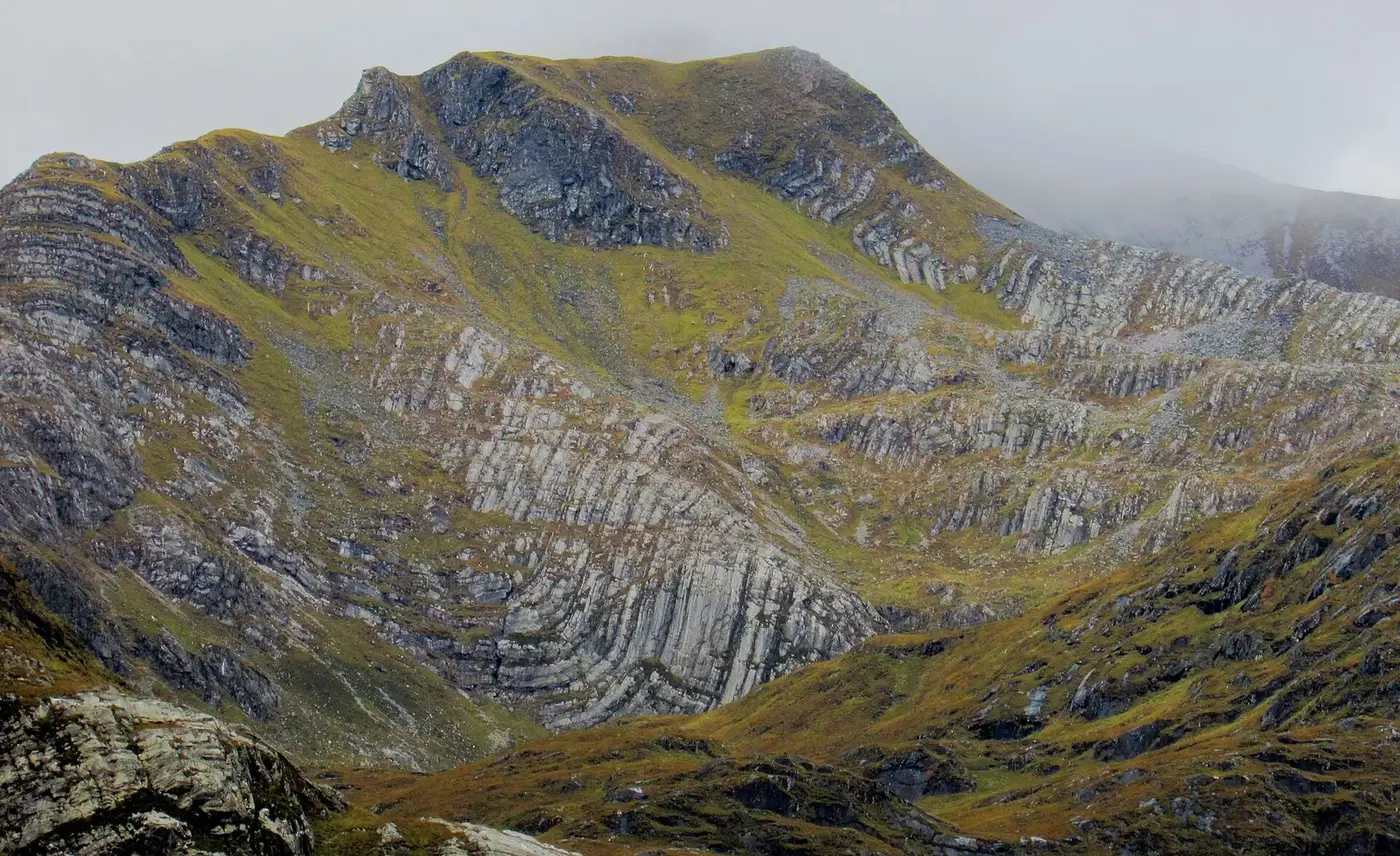 Folded and faulted rock strata exposed on a mountainside