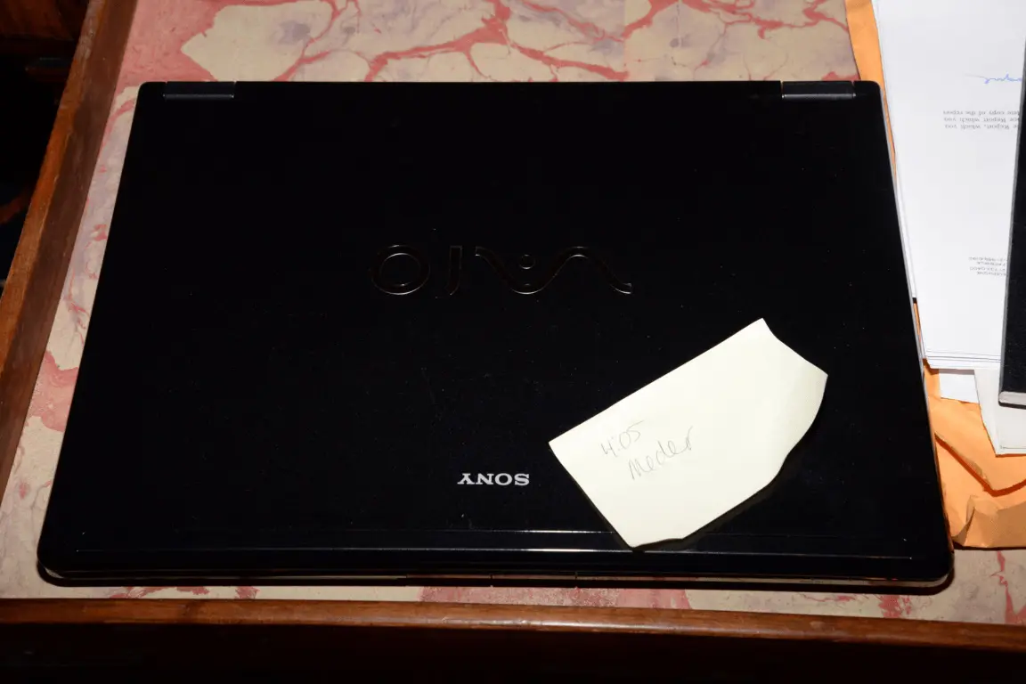 A closed laptop resting on a patterned surface