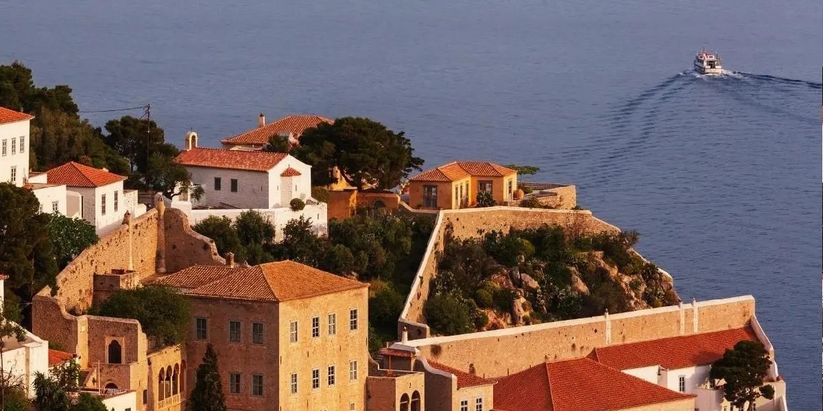 Stone houses stacked above the harbour at Hydra
