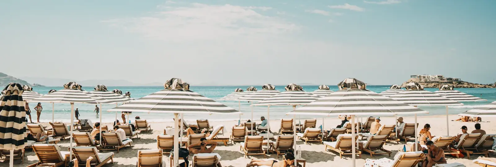 Sunbeds and shallow water at Agios Georgios, the town beach of Naxos Chora