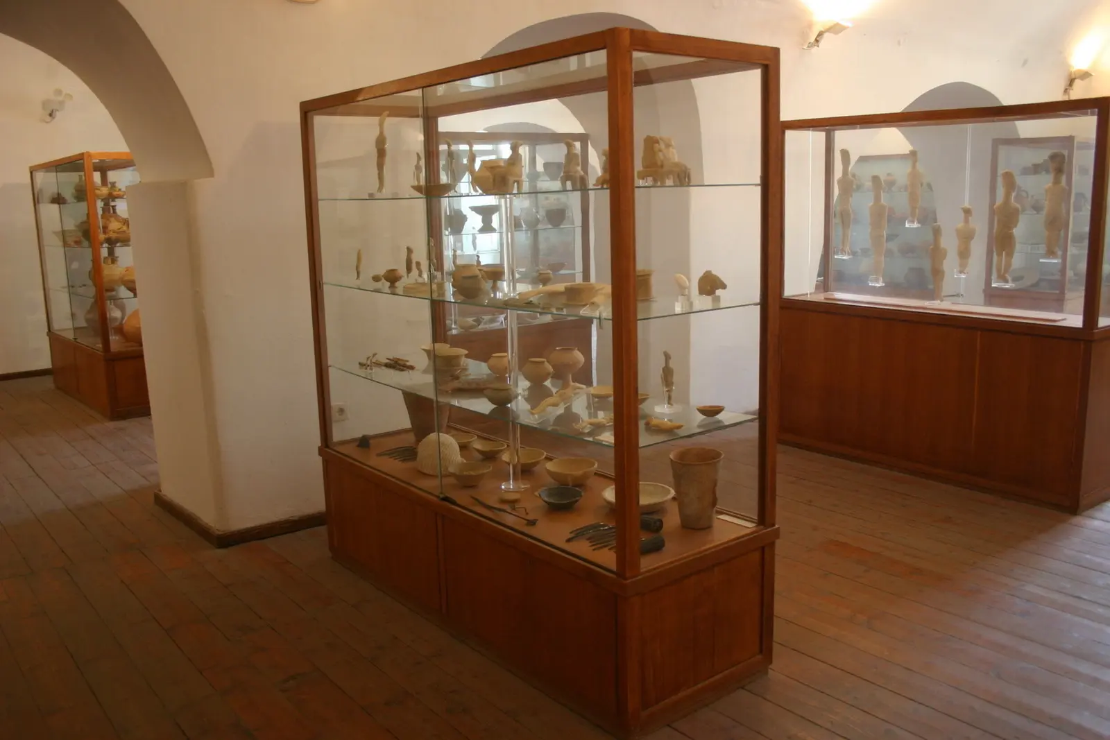 Display cases of Cycladic figurines and pottery from the Archaeological Museum of Naxos