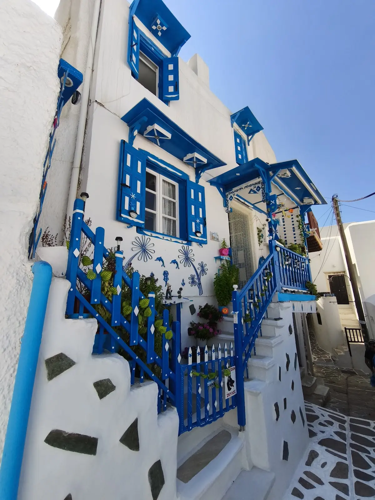 A blue-shuttered house on a marble-paved lane in the Bourgos old market quarter of Naxos Chora