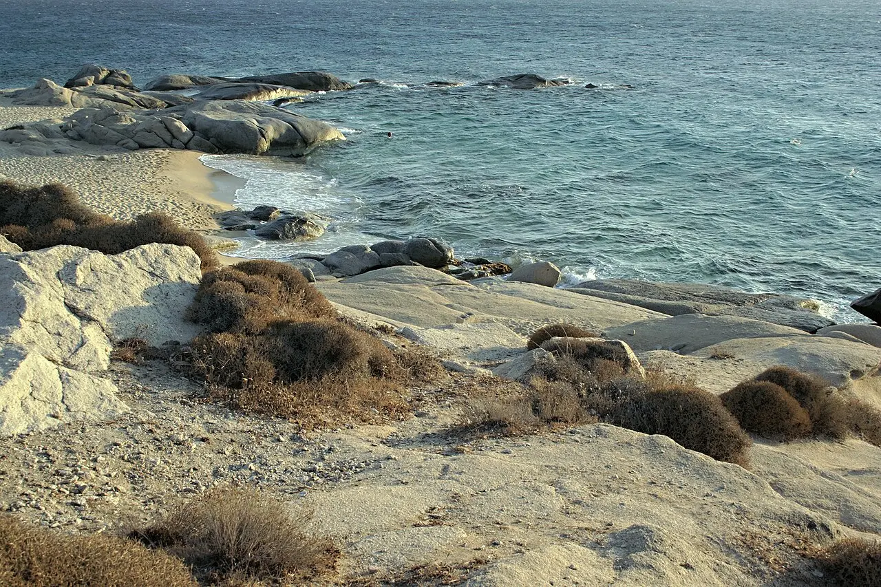 Agia Anna beach on Naxos, organised sand with tavernas behind a small port