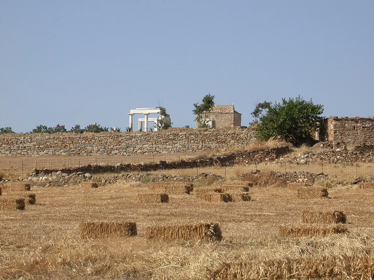 The partially re-erected Ionic Temple of Demeter at Gyroulas near Sangri, white Naxian marble on a low hill